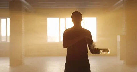 Professional bartender juggles bottles. The bartender is practice in hall at Video stock 154358712