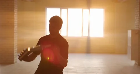 Professional bartender juggles bottles. The bartender is practice in hall at Stock Footage 154359084