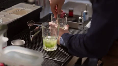 Professional Bartender Making Fresh Mojito Cocktail With Authentic Muddling Stock Footage 337777739