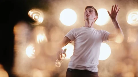 The professional bartender man juggling bottles on the light smoke background Vídeo Stock 151417284