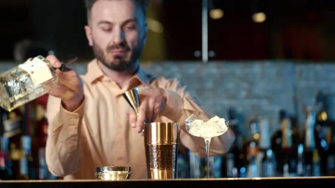 Professional bartender masterly creating a cocktail in modern bar. Video stock 239101822