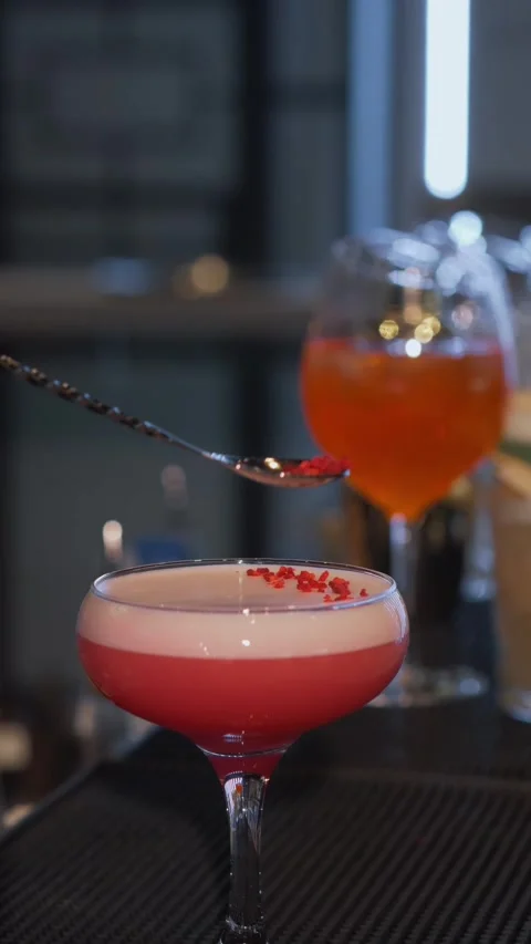 A professional bartender prepares a pink alcoholic cocktail. Stock Footage 270806747