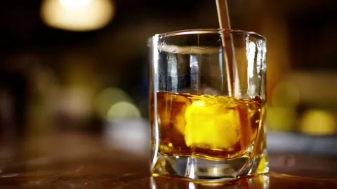 A professional bartender preparing an alcoholic cocktail with ice cube to Video stock 264991325