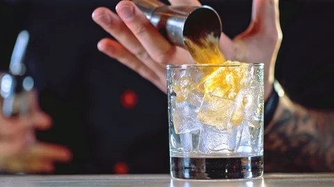 Professional bartender preparing a cocktail with ice Stock Footage 85603449