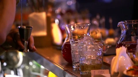 Professional bartender preparing a cocktail with ice a mix of alcohol. The Stock-Footage 104491682