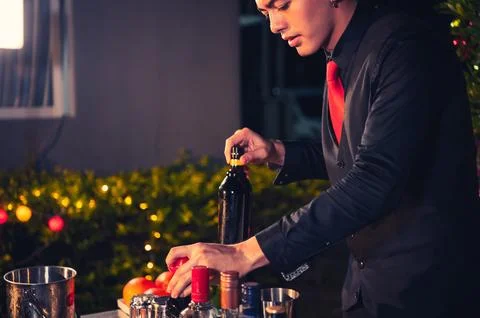Professional bartender preparing fresh lime lemonade cocktail in drinking w.. Photos