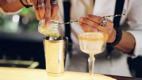 Professional bartender putting crushed ice into a shaker Stock Footage 337885380