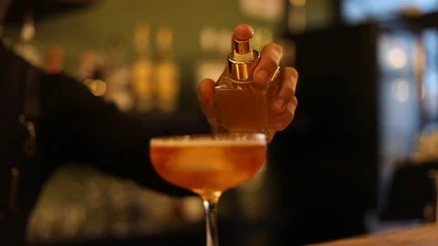 Professional Bartender Spraying Aromatic Essence on Top of Cocktail Stock Footage 129781948