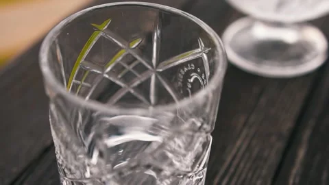 Professional bartender throws ice into empty glass shot Stock-Footage 153089590