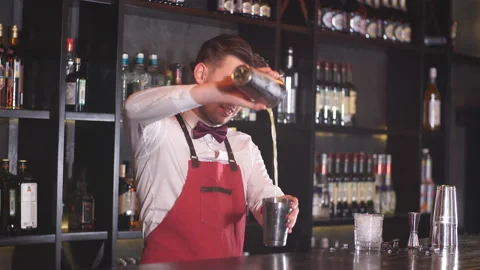 Professional bartender in uniform doing show of his work Stock Footage 104540007