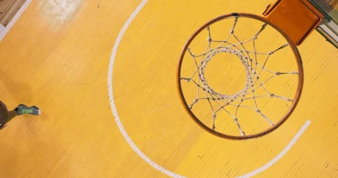 Professional basketball player in action performing slam dunk Stock Footage