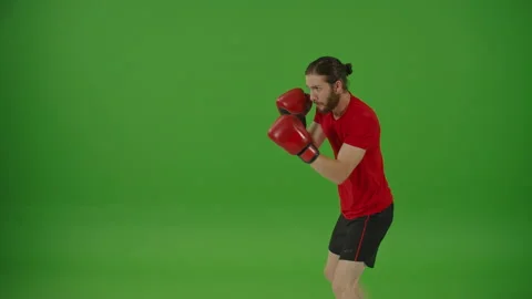 Professional Bearded Fighter Doing Boxing Exercises while Wearing Sportswear Stock Footage 220470475