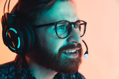 Professional bearded gamer playing the computer game on a tournament - Focused Stock Photos