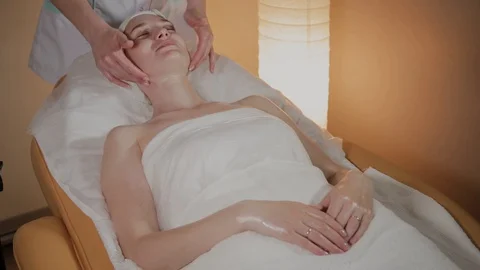 Professional beautician makes a complex massage to a young girl in the 库存影片 109849095