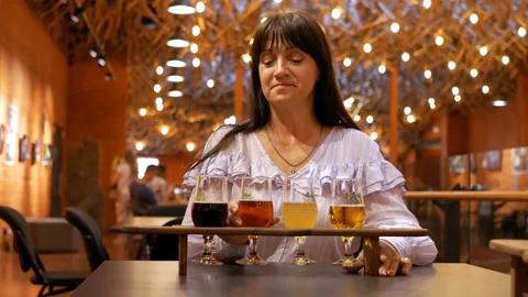 Professional beer taster tries several types of drinks and is pleased with the Stock Footage 94307238