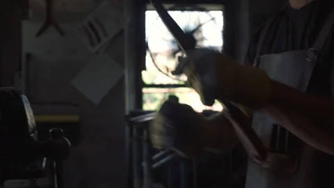Professional blacksmith filing metal Stock Footage 128597992