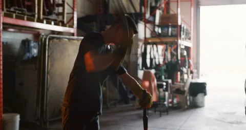Professional blacksmith hammering a red hot piece of metal in interior blacksmit Video stock 199459153