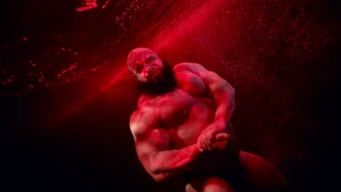 Professional bodybuilder is posing inside water in depth of pool or aquarium 動画素材 194716418