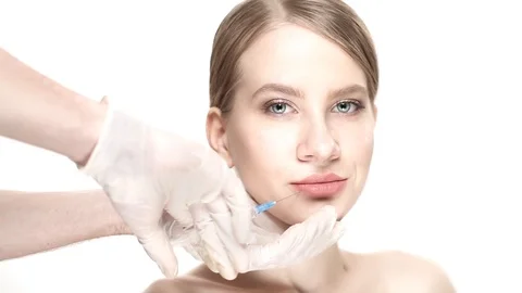 Professional a botox injection in lower lip then the woman smiles Stock Footage 88287642