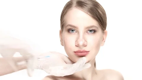 Professional a botox injection in lower lip then the woman smiles Stock Footage 88287645