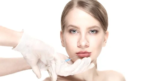 Professional a botox injection in lower lip of the beautiful woman Video stock 88287647