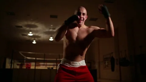 A professional boxer in the background of the ring holds shadow close-up, camera Stock Footage 83968589