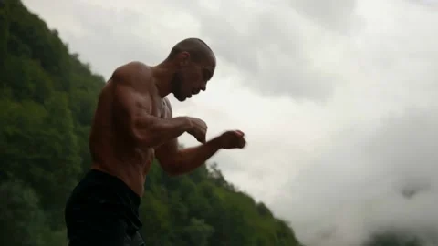 Professional boxer or fighter is training alone in nature, striking to air 库存影片 163330778