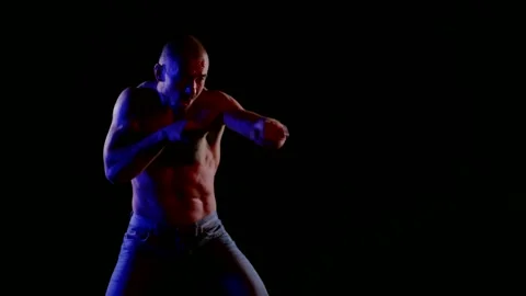 Professional boxer is practicing strikes by hands in night 库存影片 165934670