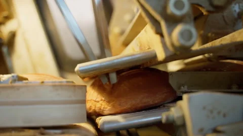 Professional bread cutting mechanism inside long loaf slicer on factory indoors Stock Footage 250274566