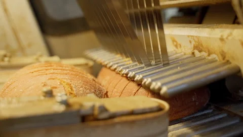 Professional bread cutting mechanism inside long loaf slicer on factory Stock Footage 250275133