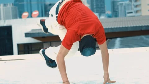Professional break dancer doing head spin at roof top with city view. hiphop. Stock Footage 258351877
