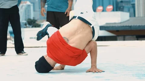Professional break dancer doing head spin at roof top with city view. hiphop. Stock Footage 268346360