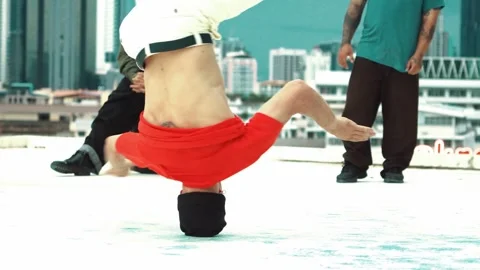 Professional break dancer doing head spin at roof top with city view. hiphop. Stock Footage 270703735