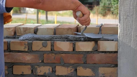 Professional bricklayer building a brick wall, close up Stock Footage 323717726