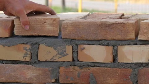 Professional bricklayer building a brick wall, close up Stock Footage 323717797