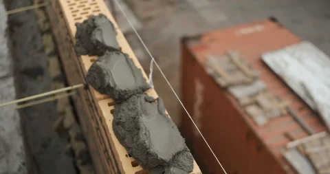 Professional bricklayer at construction site masterfully builds wall of brick Stock Footage 118295516