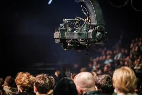 Professional broadcast camera rig filming live audience at indoor event Stock Photos