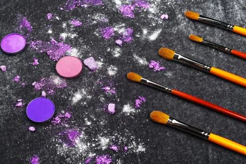 Professional brushes and crashed eyeshadow Stock Photos