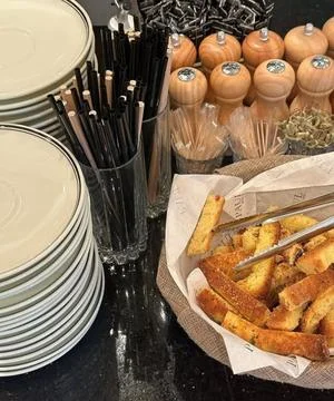 Professional Buffet Setup with Elegant Tableware and Bread Service Display Stock Photos