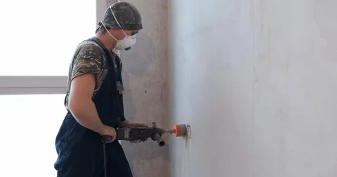 Professional builder drill recess in brick wall under wall outlet, deep hole Stock Footage 128638806