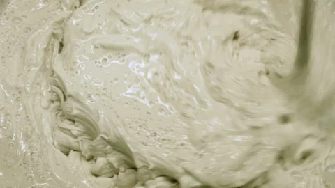 Professional builder kneads putty with water in a bucket using a hand-held mixer Stock Footage 150632288