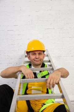 A professional builder with a ladder, compact and ready to work at any time. 写真素材