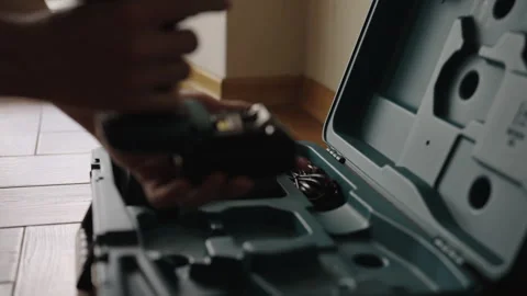 Professional builder preparing for work by taking cordless electric drill out of Stock Footage 342765587
