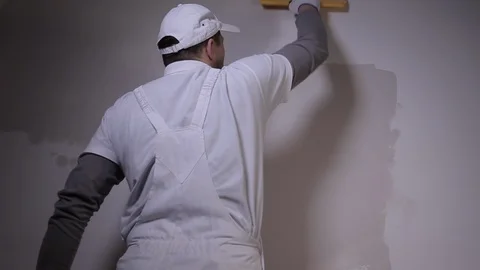 Professional builder with spatula Applies Plaster To The Wall Stock Footage 101382924