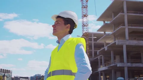 Professional builder standing in front of construction site. Foreman in hardhat Stock Footage 137772473