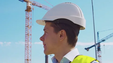 Professional builder standing in front of construction site. Foreman in hardhat Stock Footage 307691380