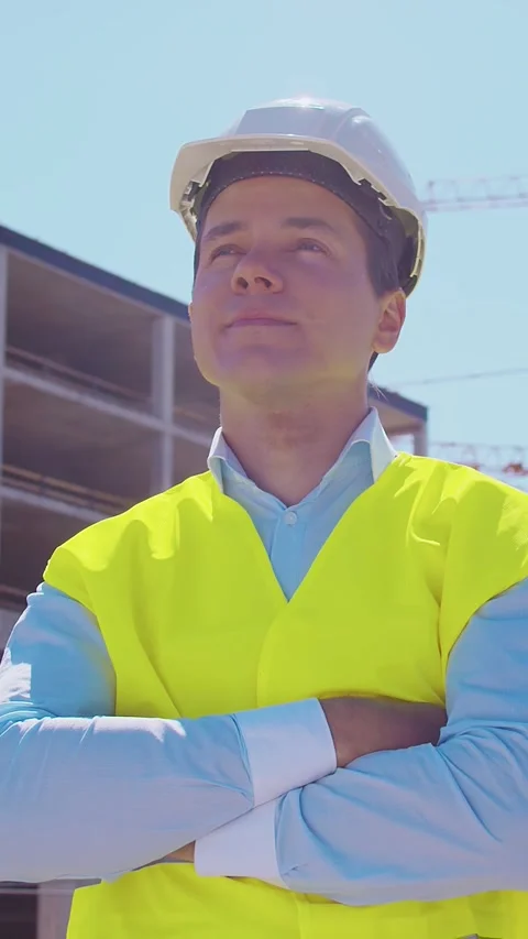 Professional builder standing in front of construction site. Foreman in hardhat Stock Footage 307692625
