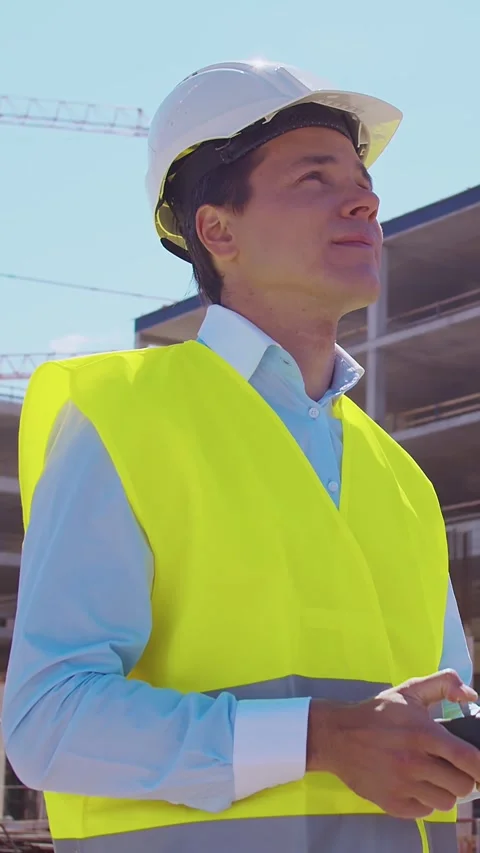 Professional builder standing in front of construction site. Foreman in hardhat Stock Footage 307692968