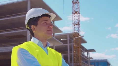 Professional builder standing in front of construction site. Foreman in hardhat Stock Footage 307936813