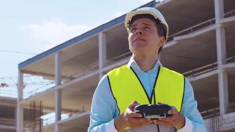 Professional builder standing in front of construction site. Foreman in hardhat Stock Footage 307937416